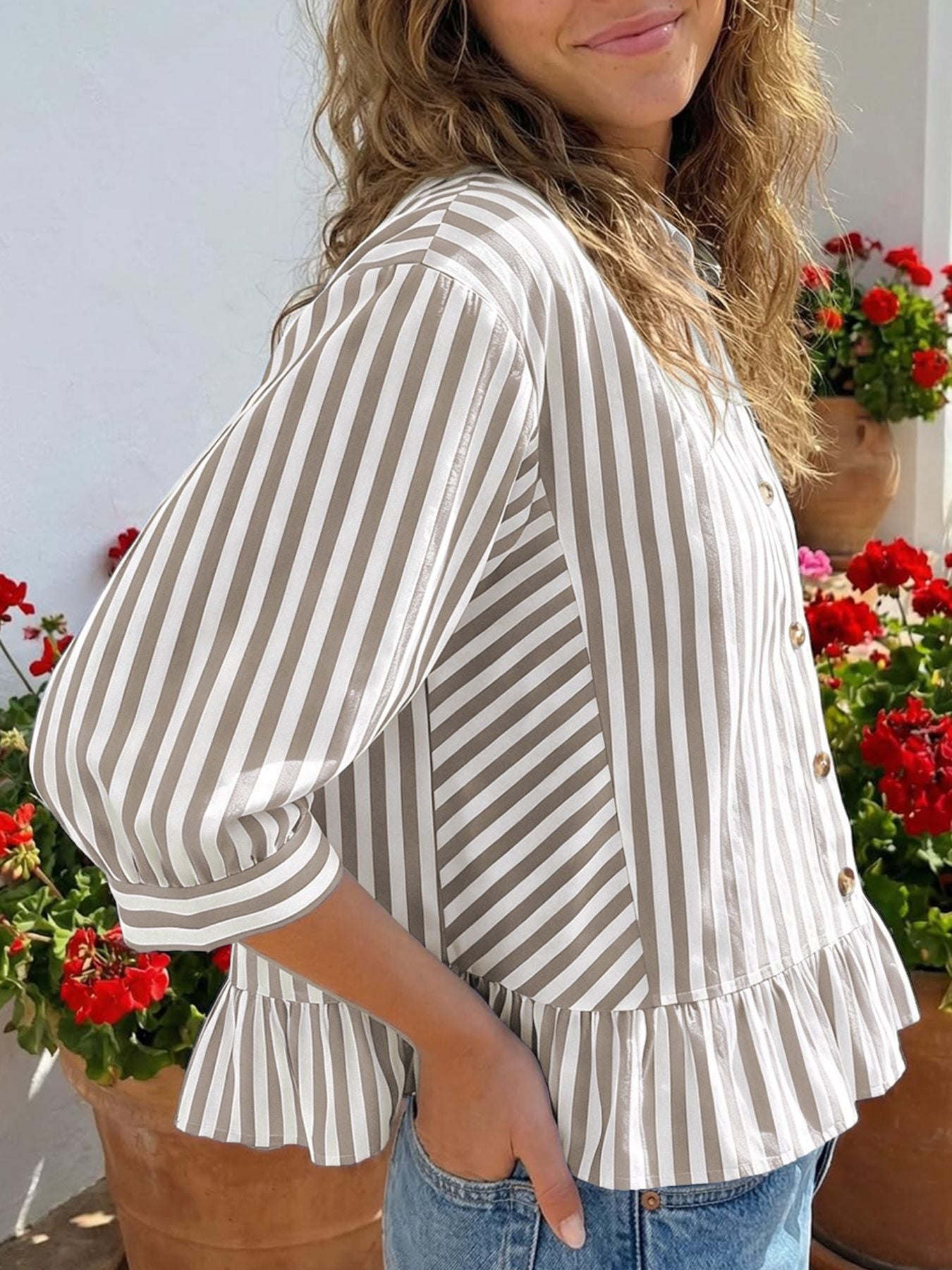Button-down shirt with 3/4 sleeves, ruffle hem, and vertical stripes in khaki and white.
