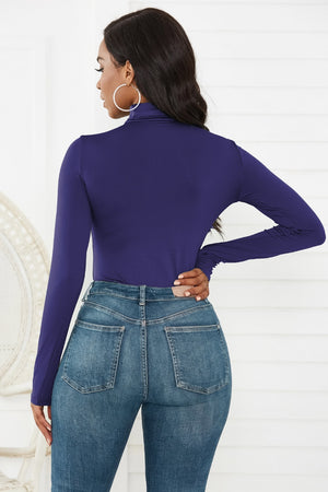 Royal Blue long sleeve turtleneck bodysuit with thong back, paired with blue denim jeans.