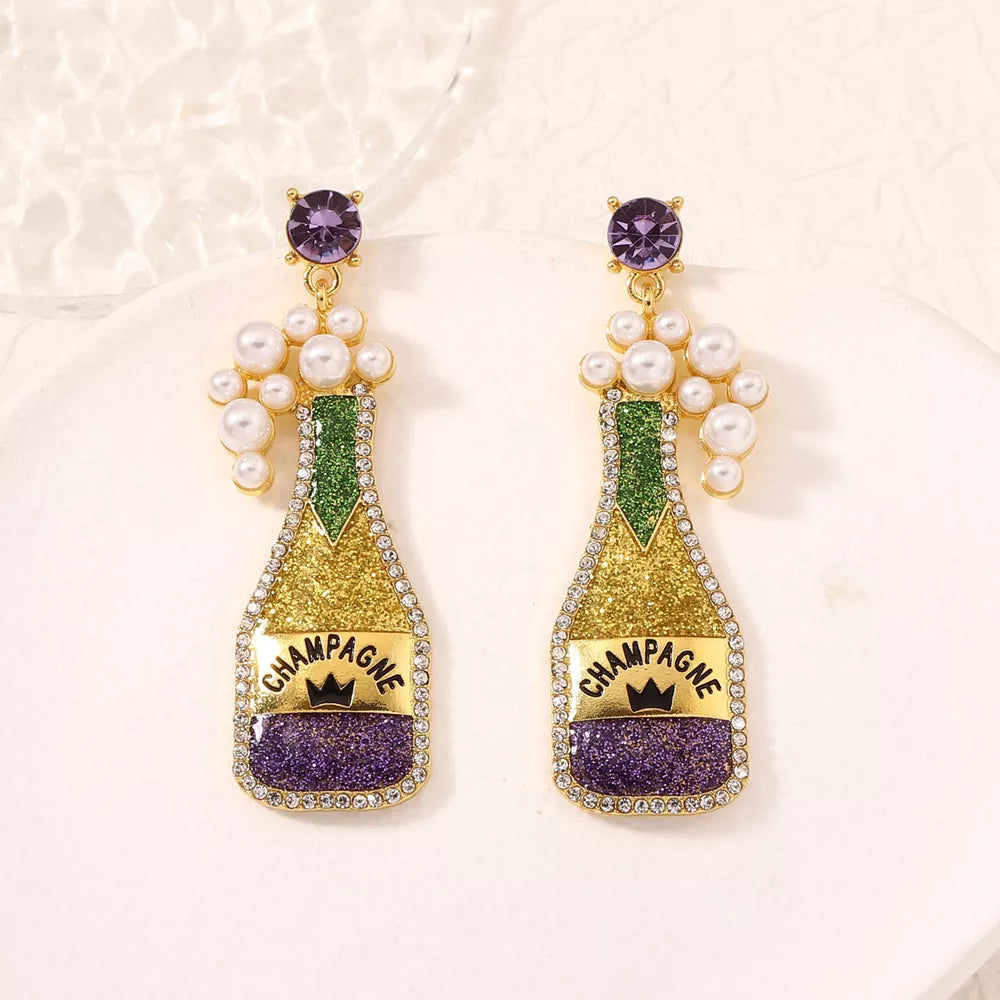 Champagne celebration pearl earrings in gold with purple accents and faux pearls.
