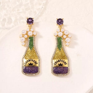 Champagne celebration pearl earrings in gold with purple accents and faux pearls.