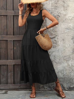 Black smocked bodice tiered maxi dress with scoop neck and sleeveless design
