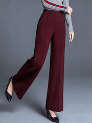 Burgundy high-waisted wide leg trousers with pockets and front seam detail.