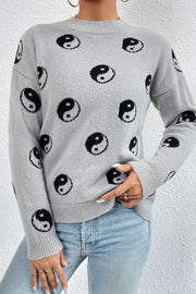 Light gray acrylic mock neck knit sweater with black yin yang pattern and ribbed cuffs.