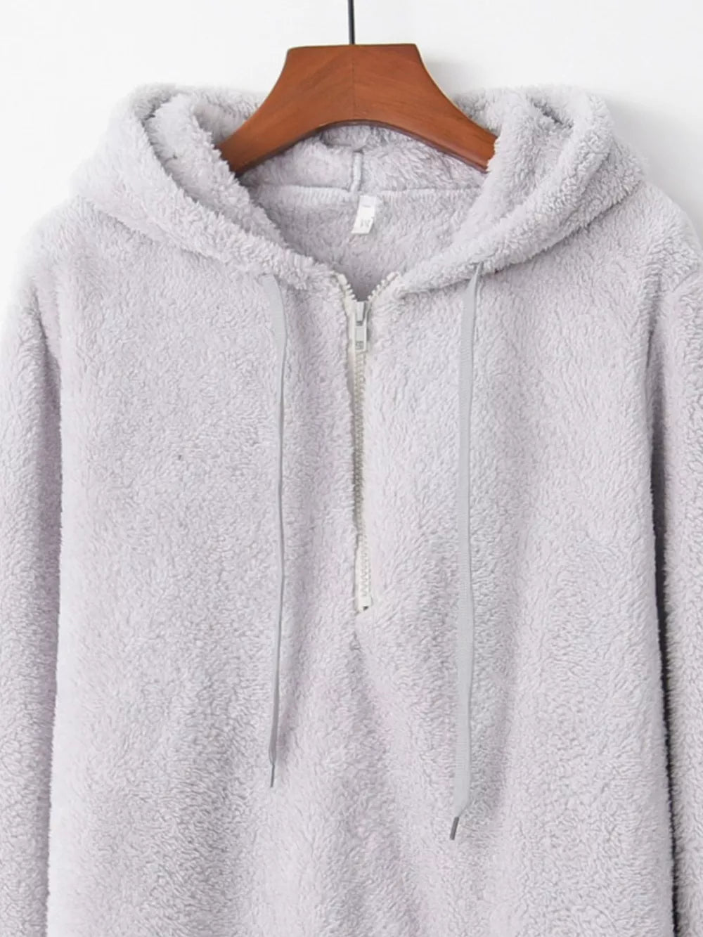 Light gray fuzzy fleece half-zip hoodie with drawstring and hood.