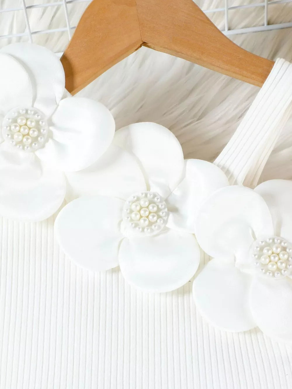 White cotton tank top with floral applique and pearl details.