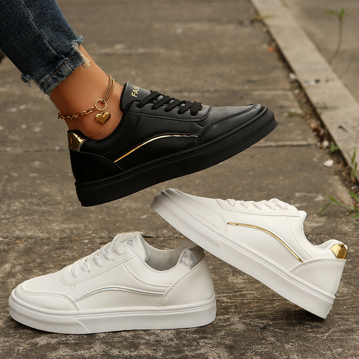 Black and white lace-up casual sneakers with gold accents and premium materials.