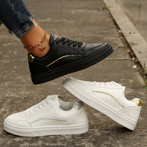 Black and white lace-up casual sneakers with gold accents and premium materials.