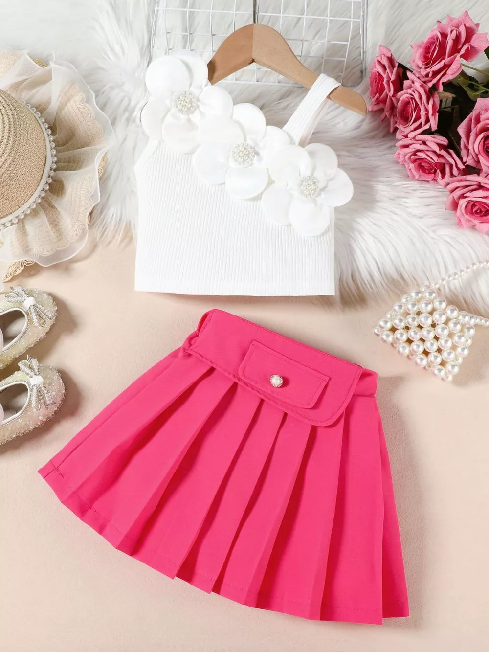 White floral applique tank top and pink pleated skirt outfit for baby girls.