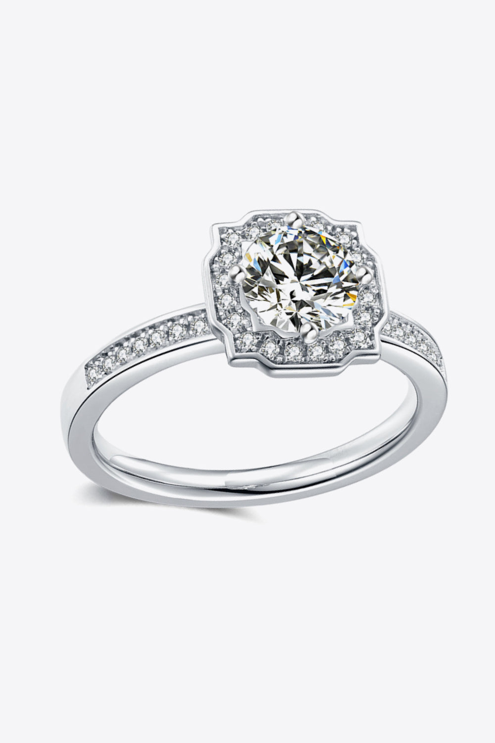 Silver halo engagement ring with a central round diamond and pavé band.