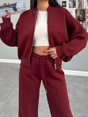 Burgundy zip-up bomber jacket and drawstring pants loungewear set with white crop top.