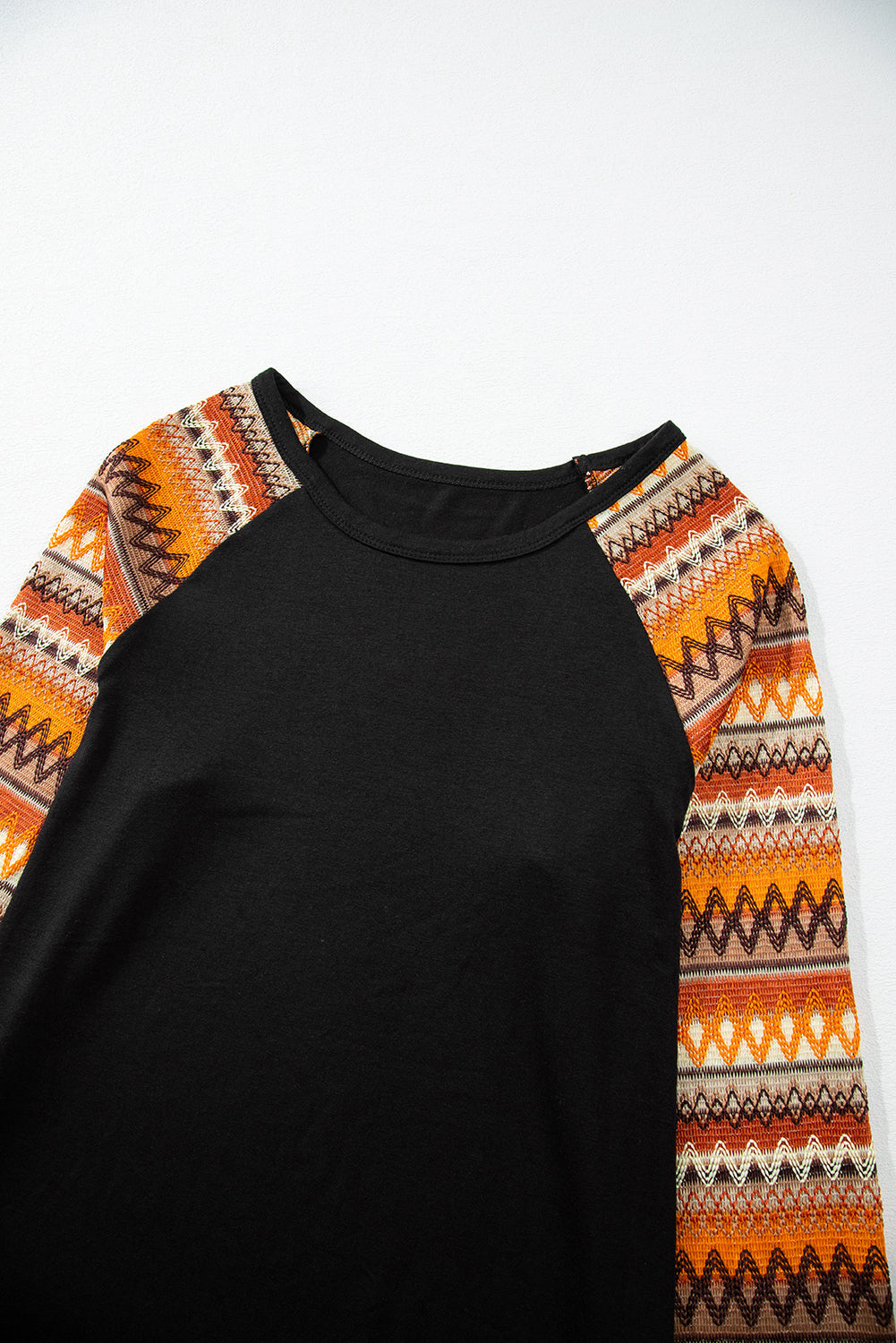 Black raglan tee with orange Aztec print sleeves