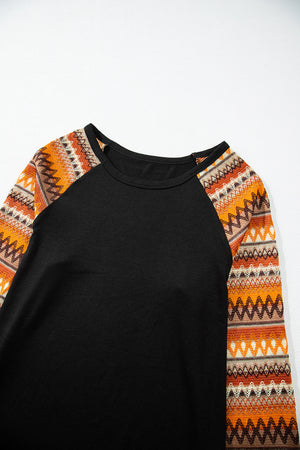 Black raglan tee with orange Aztec print sleeves