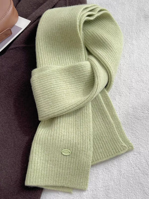 Luxe ribbed knit wool scarf in Gum Leaf green with a small oval logo detail.
