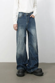 Oversized wash-effect palazzo jeans in medium blue denim with a wide leg and distressed details.