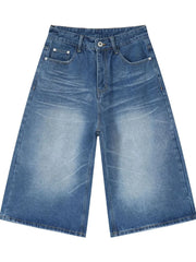 Wide-leg denim culotte shorts in medium blue wash with whiskering and distressed details.