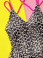 One-piece swimsuit with neon pink strappy back and black leopard print.