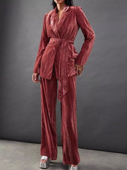 Velvet belted blazer and wide leg trousers in burgundy, styled with silver platform heels.