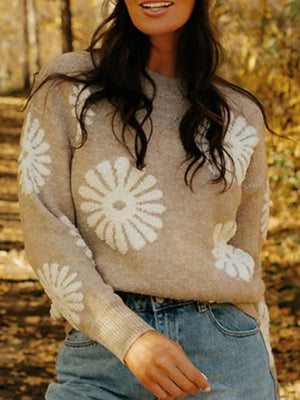 Tan knit sweater with textured floral motifs, crew neck, and long sleeves.
