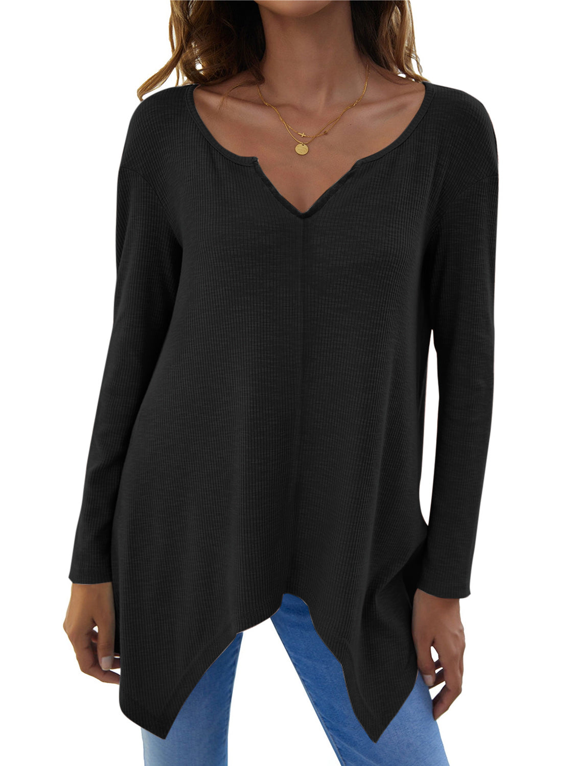 Black ribbed knit tunic with a notched V-neck and asymmetric hem.