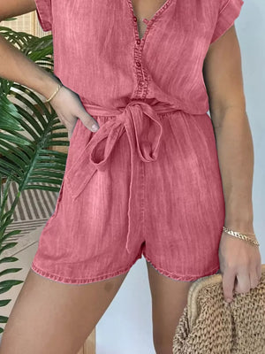 Coral tie-waist romper with button-down front and short sleeves.