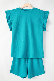 Turquoise textured co-ord set with flutter sleeves and geometric pattern.