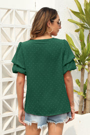 Dark green Swiss dot blouse with tiered short sleeves and a relaxed fit.