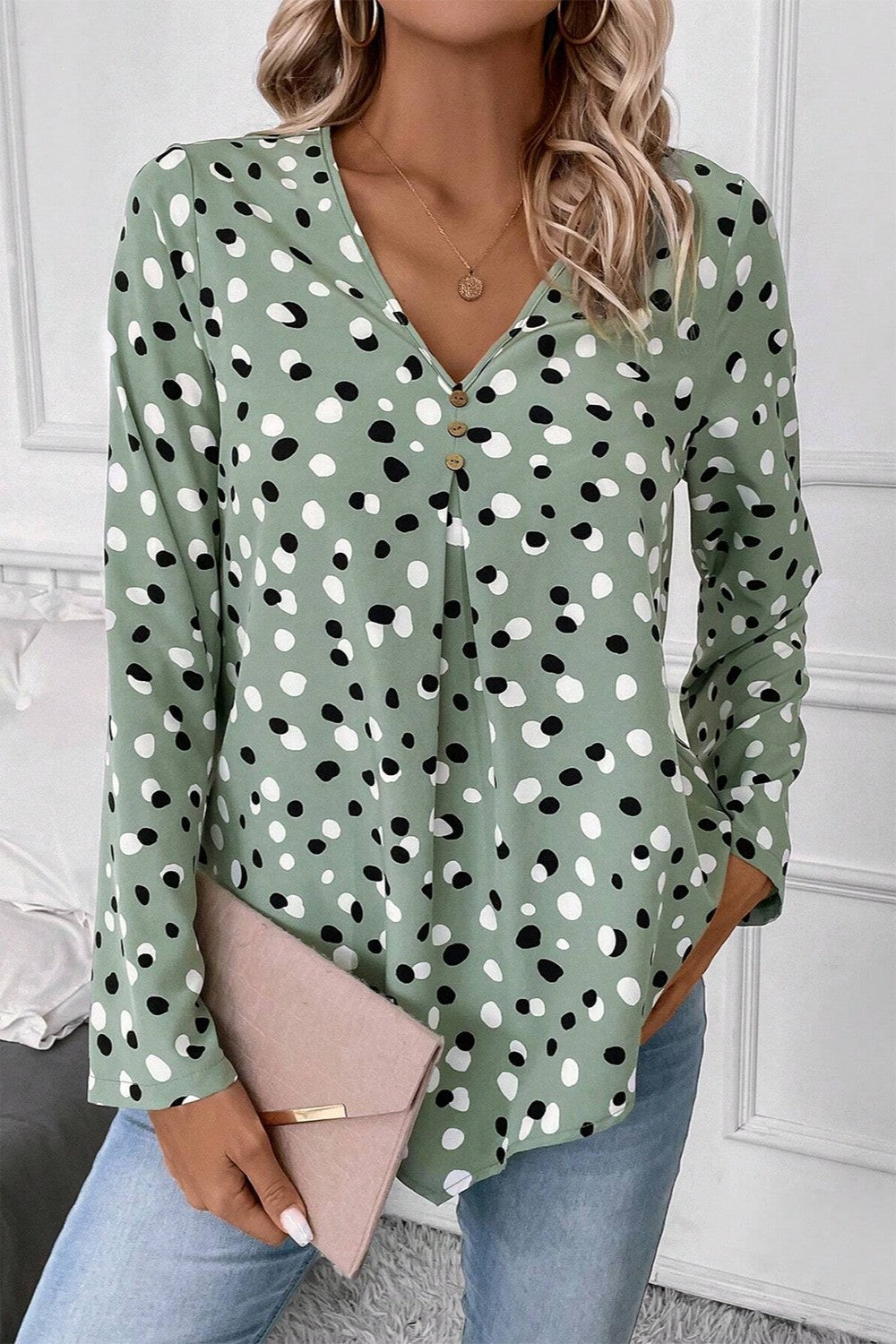 Sage polka dot button-down blouse with V-neck and front pleats.