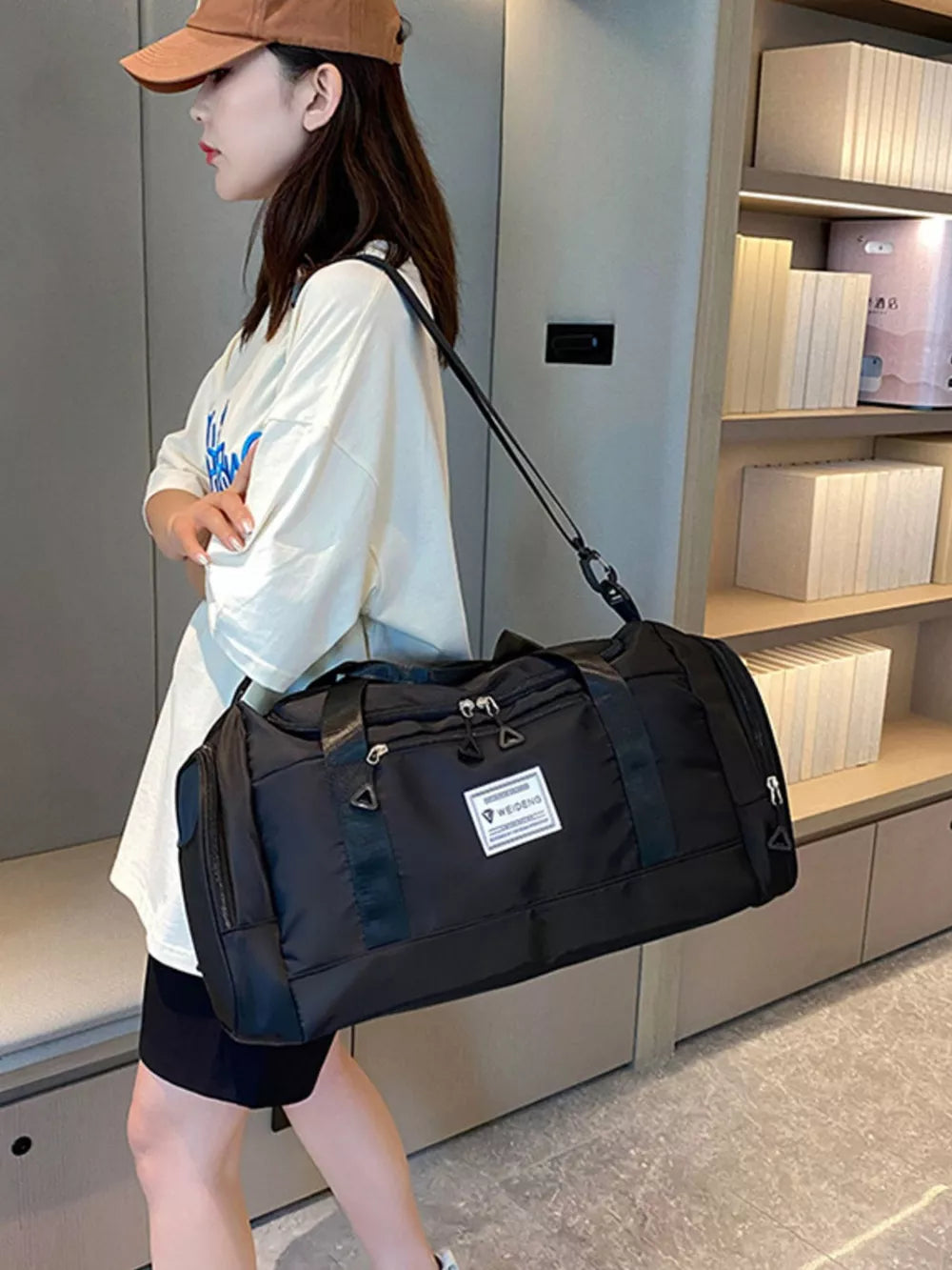 Wild Black Oxford cloth travel duffle bag with detachable strap and side pockets.
