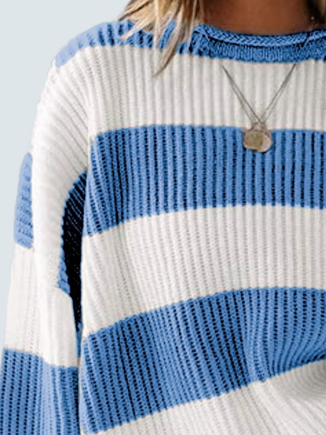 Striped knit sweater in blue and white with crew neck and relaxed fit.