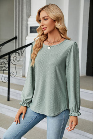 Sage textured puff sleeve blouse with ruffle cuffs and crew neck.