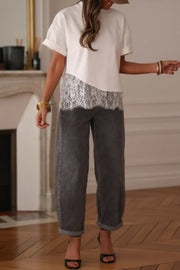 White cotton tee with asymmetrical lace trim detail and cuffed sleeves.