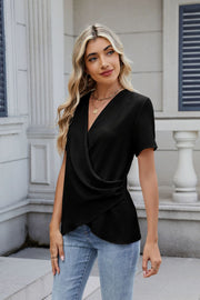 Black short sleeve blouse with draped front and ruched side detail.