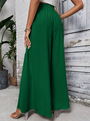 Dark green ruffled waistline palazzo trousers with a wide leg.