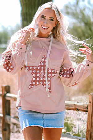 Dusty pink hoodie with floral star patchwork on the front and sleeves, featuring button cuffs.