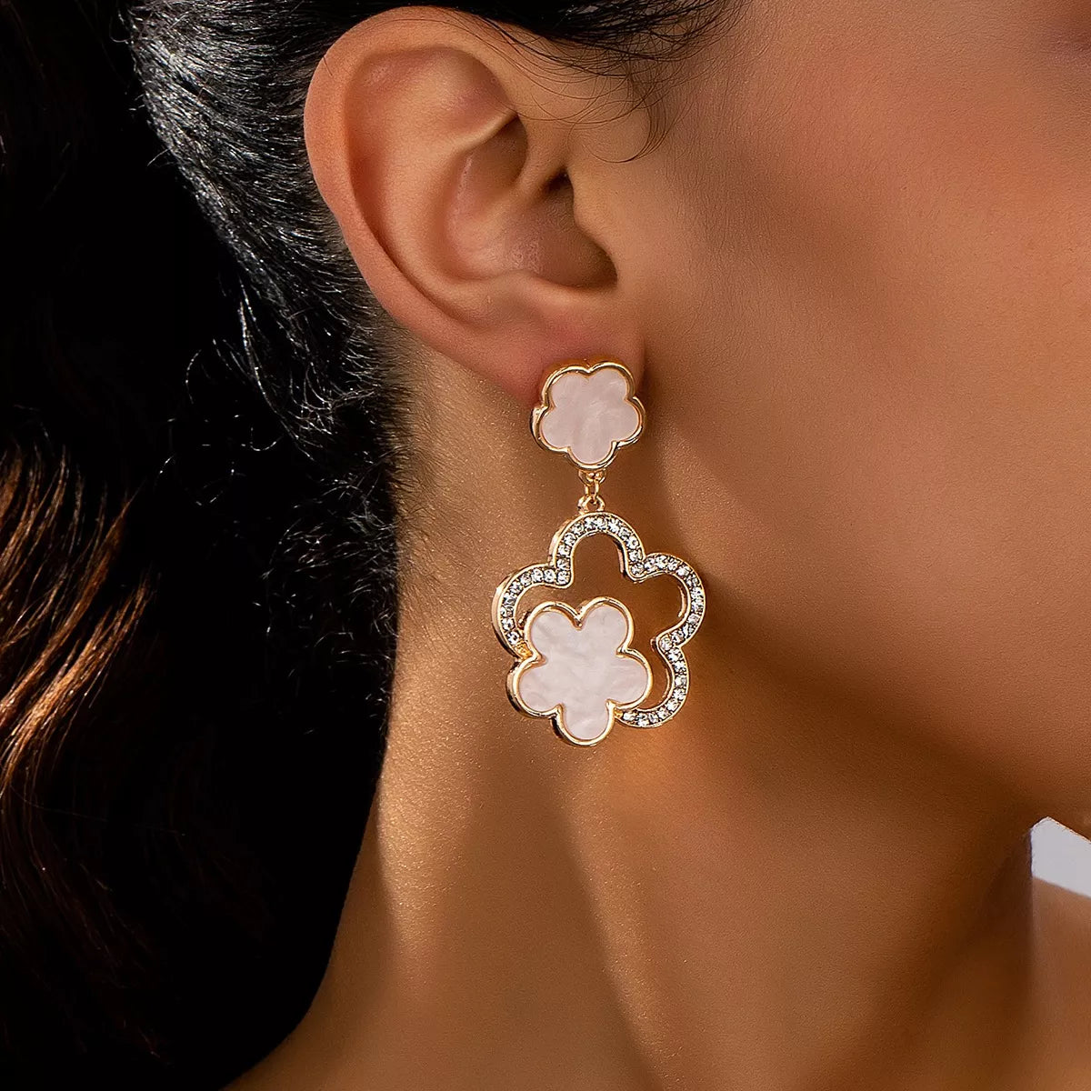White flower dangle earrings with 18K gold-plated setting and crystal accents.