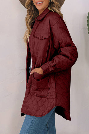 Burgundy quilted utility jacket with chest pockets and button cuffs.