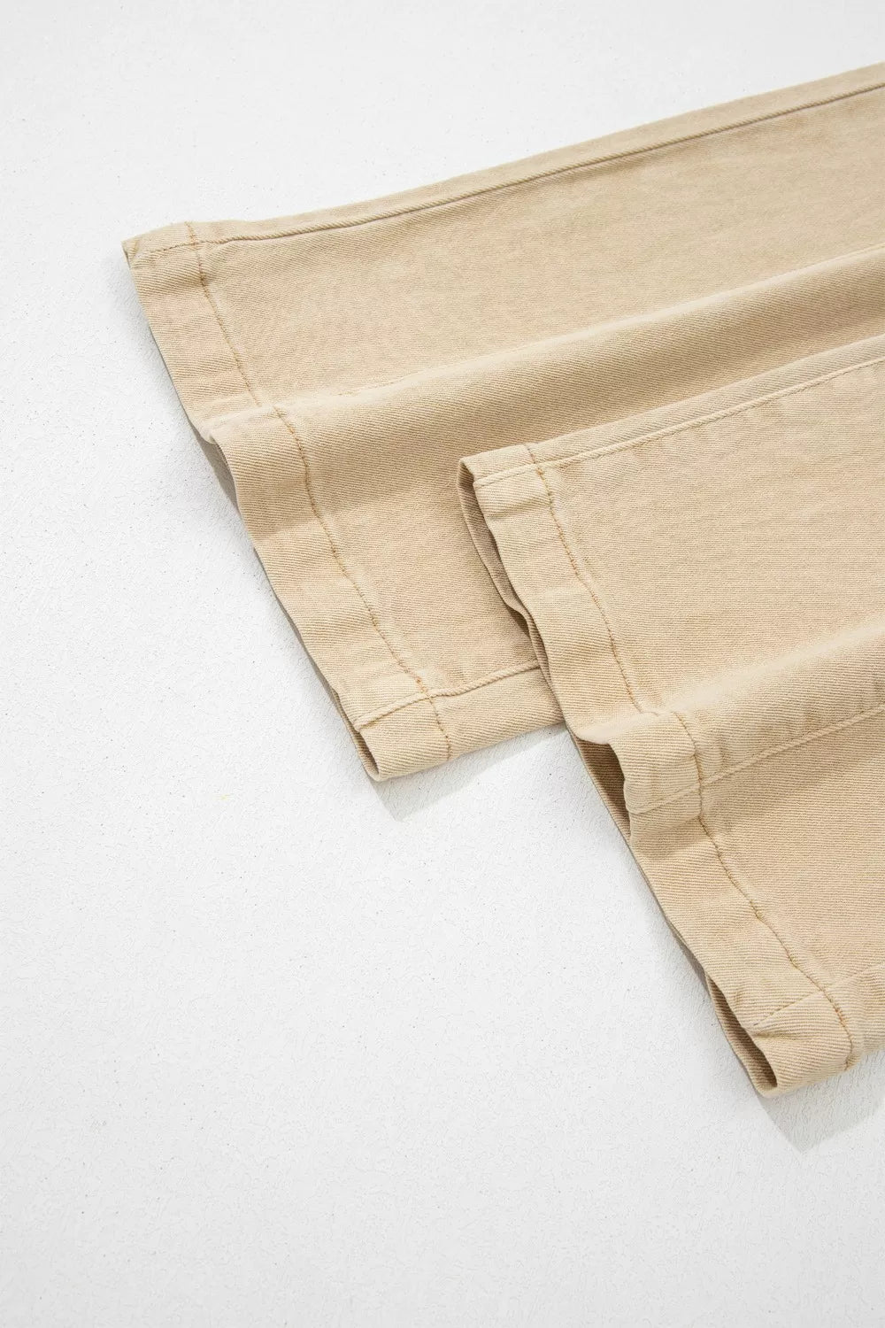 High-waisted cropped wide-leg jeans in beige denim with visible stitching detail.