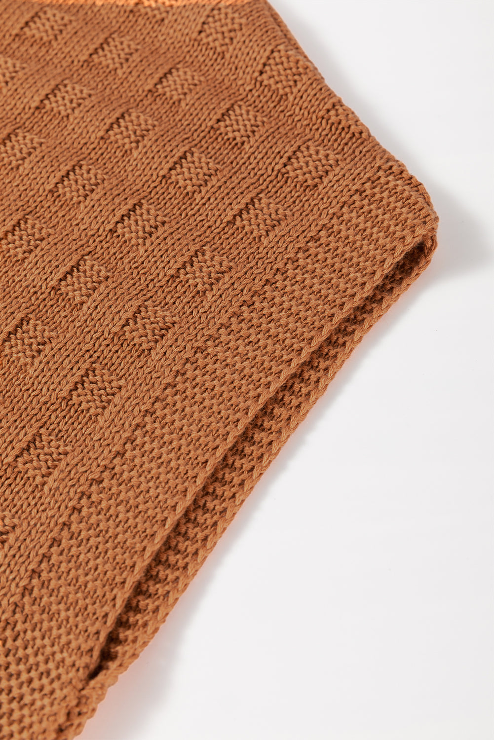 Textured knit boxy top in camel acrylic with a subtle geometric pattern.