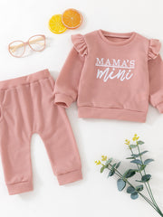 Pink cotton waffle knit toddler set with ruffled sleeves and "Mama's Mini" graphic.