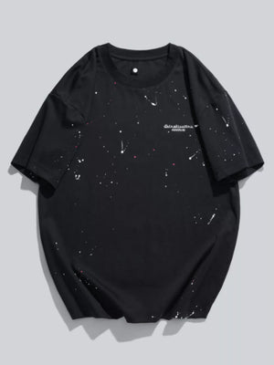 Black cotton t-shirt with white and pink paint splatter pattern and graphic text.
