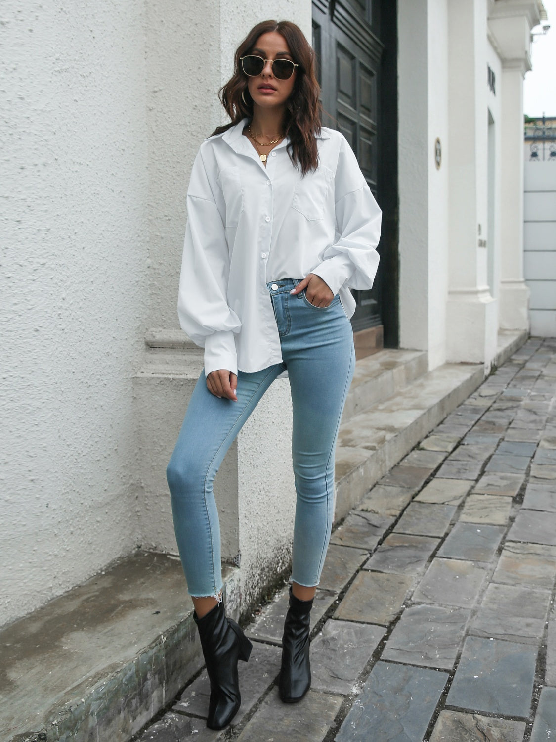 White poplin button-down blouse with balloon sleeves and a pocket.