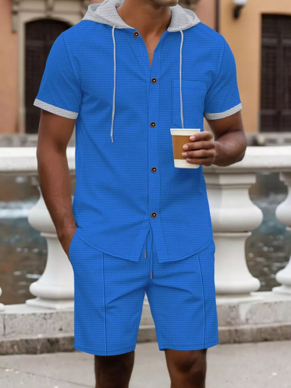 Blue hooded short sleeve button-down shirt with pocket and matching drawstring shorts.