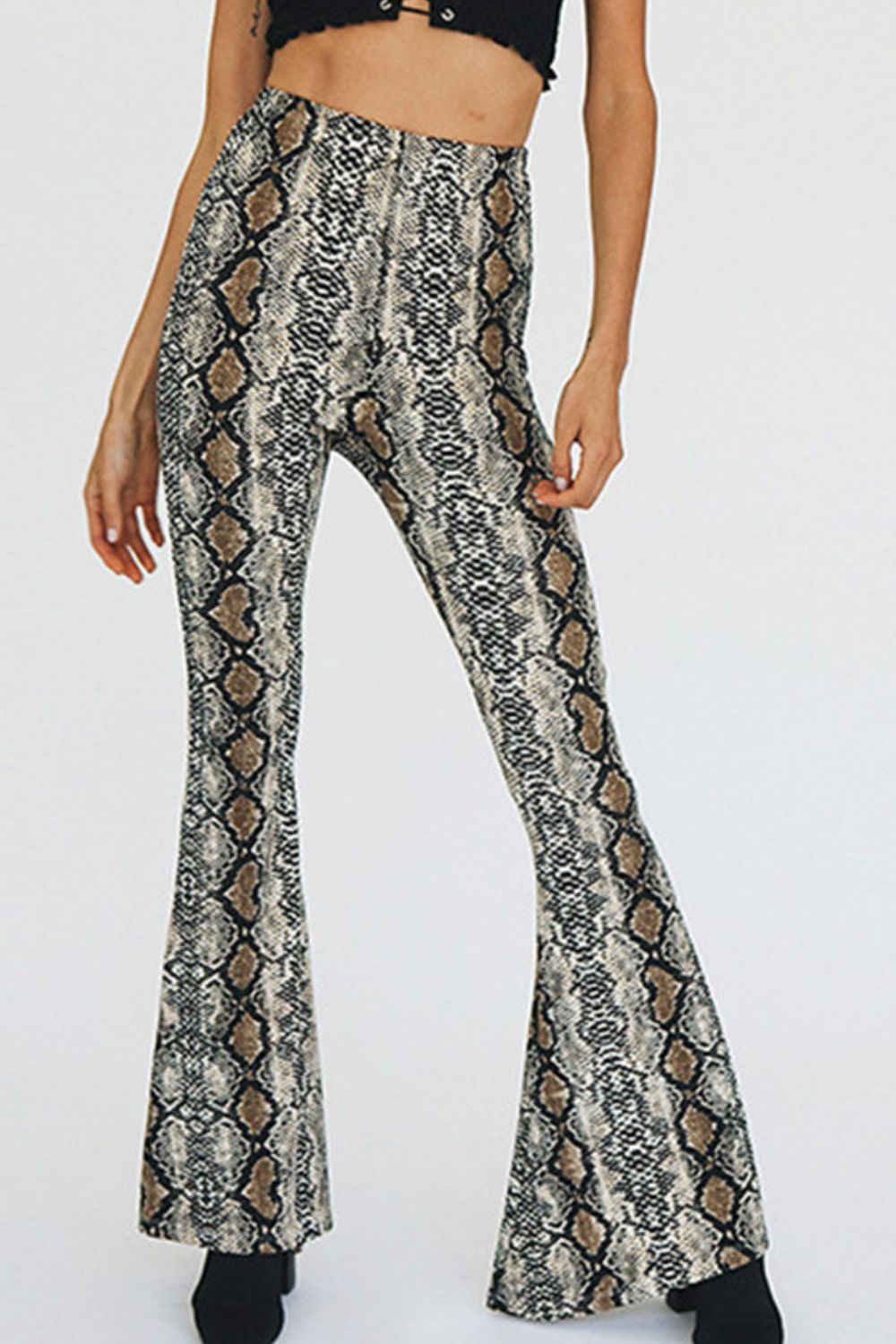 Serpentine print bell-bottom pants with a second-skin fit.