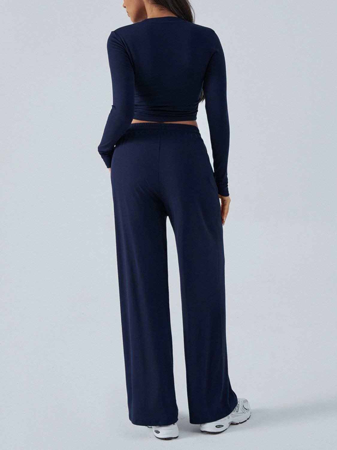 Dark blue ribbed knit crop top and wide leg pants set from behind.