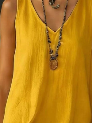 Yellow tiered ruffled hem V-neck dress with a textured fabric and layered necklace.