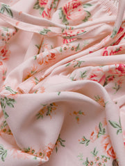Pink floral tie front puff sleeve blouse with a cropped length.