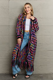 Chromatic crochet maxi cardigan with fringe in multi-color acrylic, featuring a open front and long sleeves.
