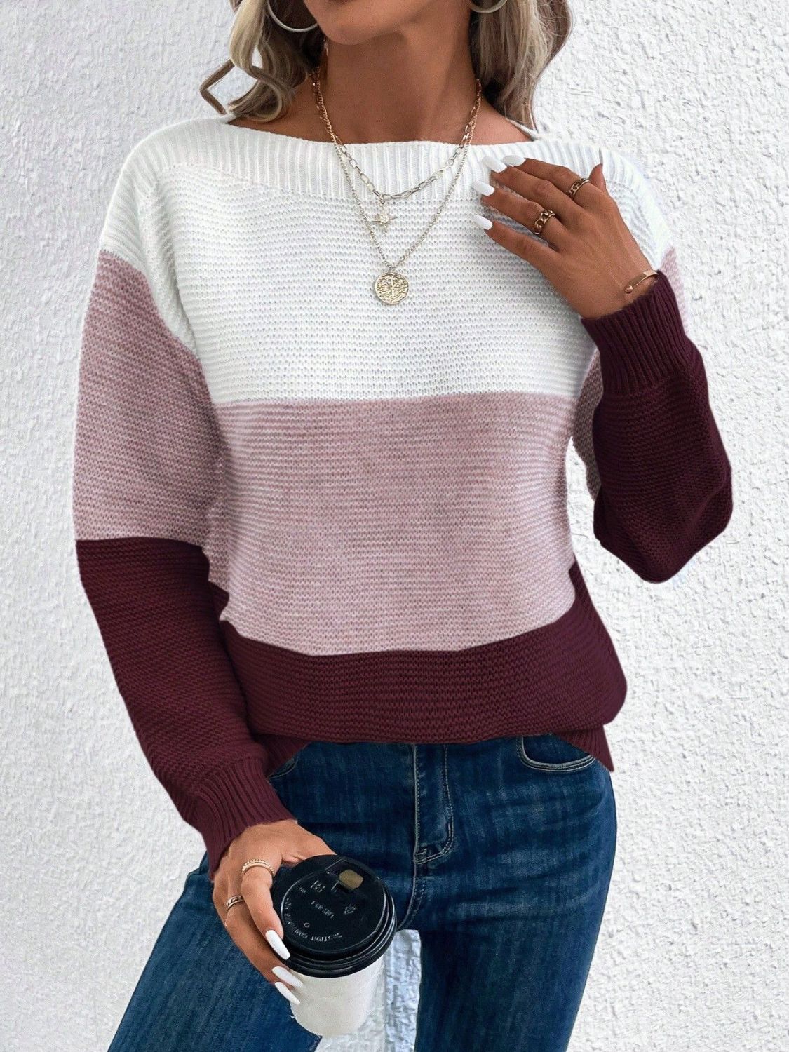 Colorblock ribbed knit sweater with boatneck in white, pink, and burgundy.