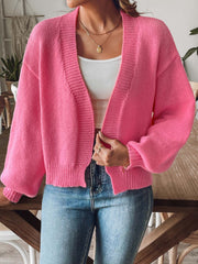 Balloon sleeve knit cardigan in strawberry pink with ribbed cuffs and open front.