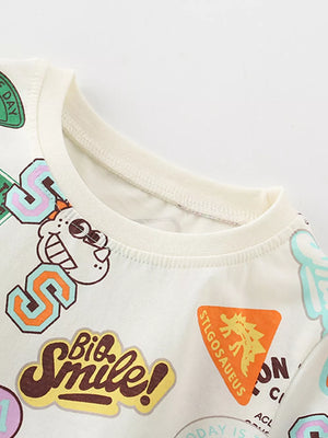 Beige cotton t-shirt with dinosaur and graphic patch prints.